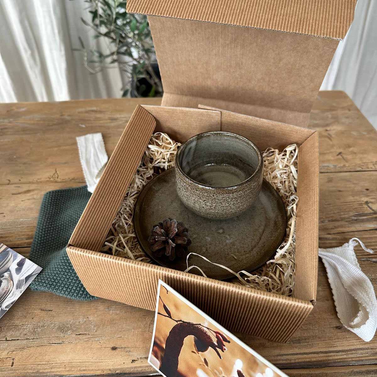 FRANZART Becherset braun-weiß im Naturkarton mit Holzwolle und Weihnachtskarte verpackt